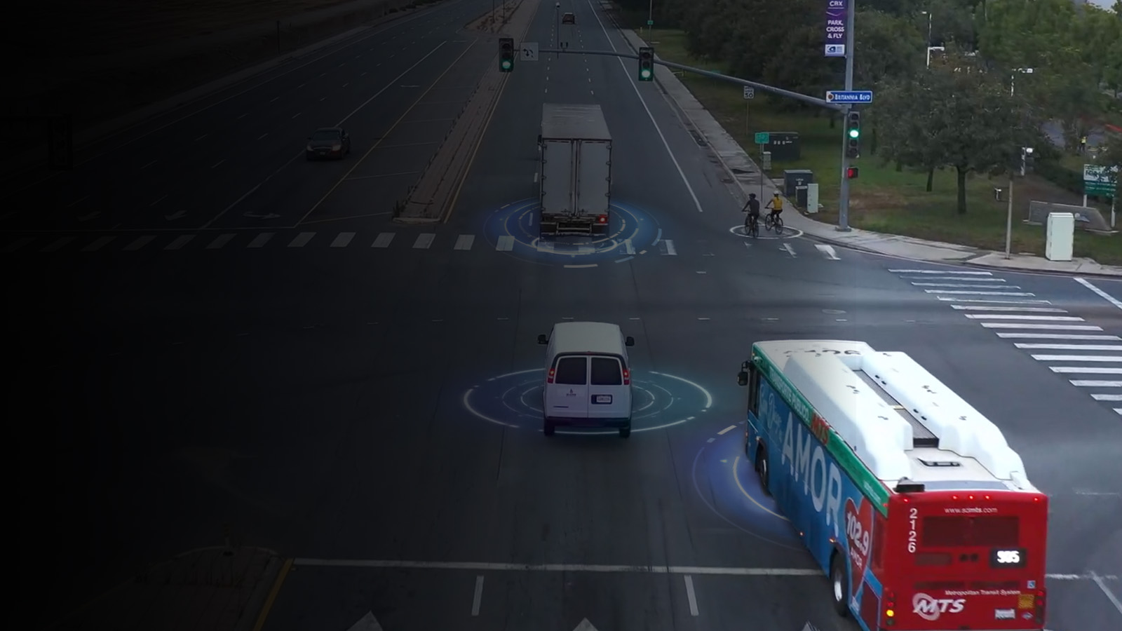 Commercial vehicles driving through a lighted intersection